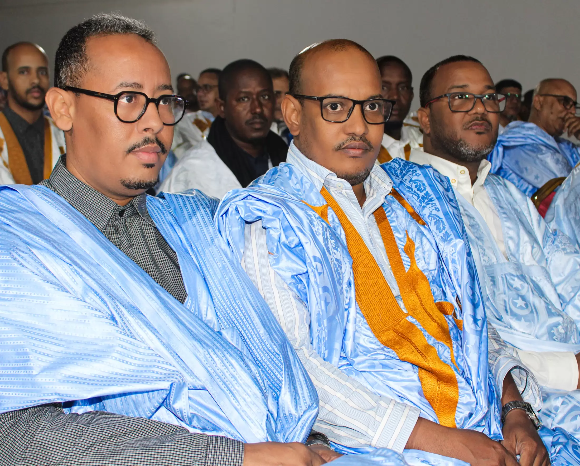 Trois participants suivent les interventions depuis la salle.